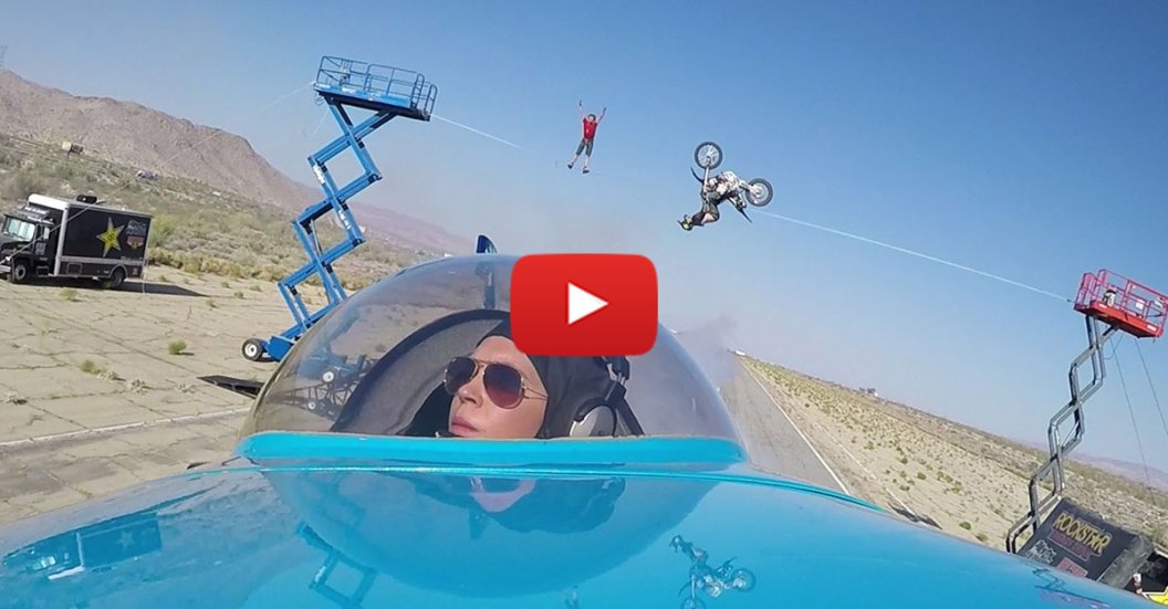 Plane-flies-under-a-tightrope-walker-while-a-bike-jumps-over-it