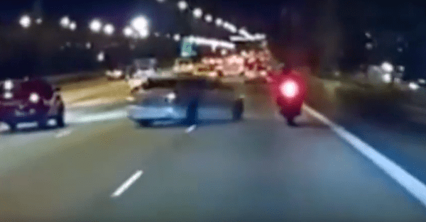 A car and a motorcycle try to out-stupid each other in a crazy road rage incident