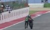 motorcycle racer pushes bike to finish line