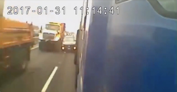 A driver’s attempt to squeeze between two trucks ends poorly