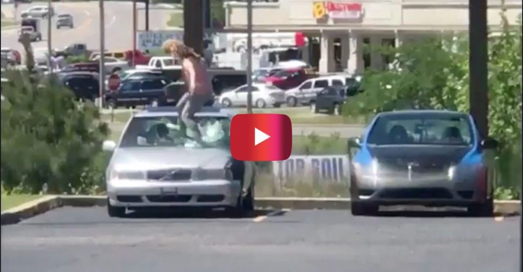 woman smashing car windshield
