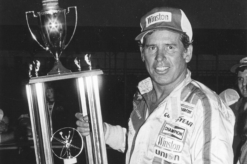 black and white photo of david pearson with trophy