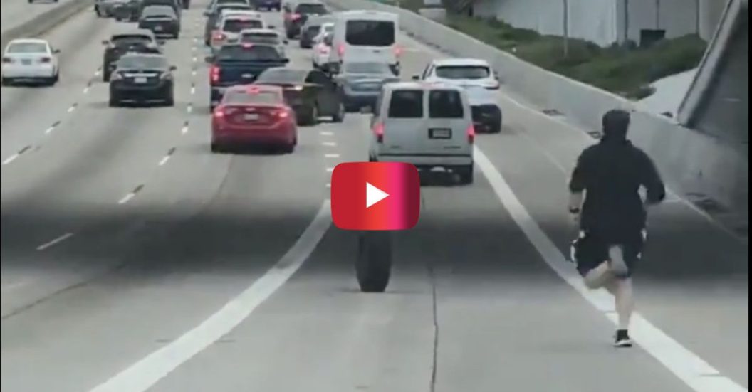 man chasing tire