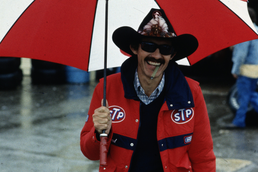 richard petty under umbrella with cigar in mouth