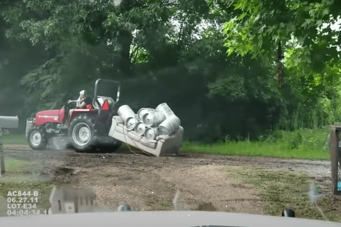 Guy Pulling a Beer Keg Couch Behind His Tractor Is an Internet Sensation