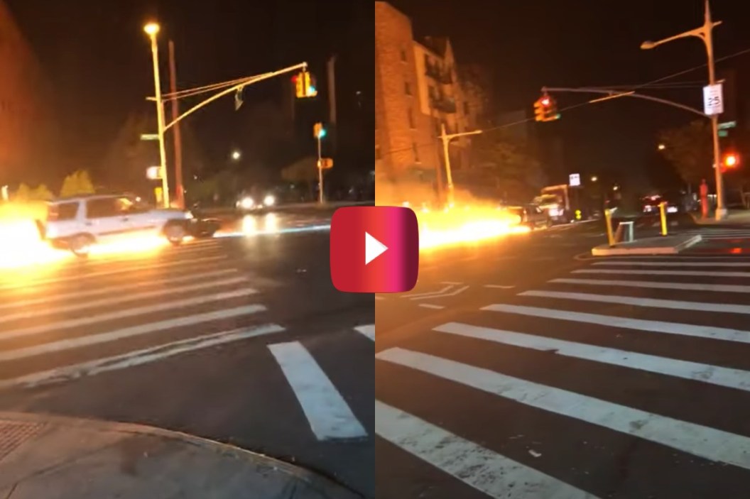 Car Pushes Flaming Motorcycle down Street