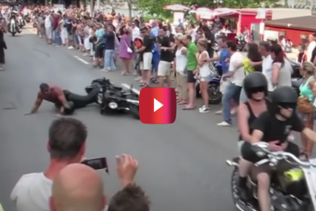 Shirtless Biker Comes in Way Too Hot and Wipes Out During Parade