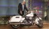 jay leno stands next to harley davidson motorcycle
