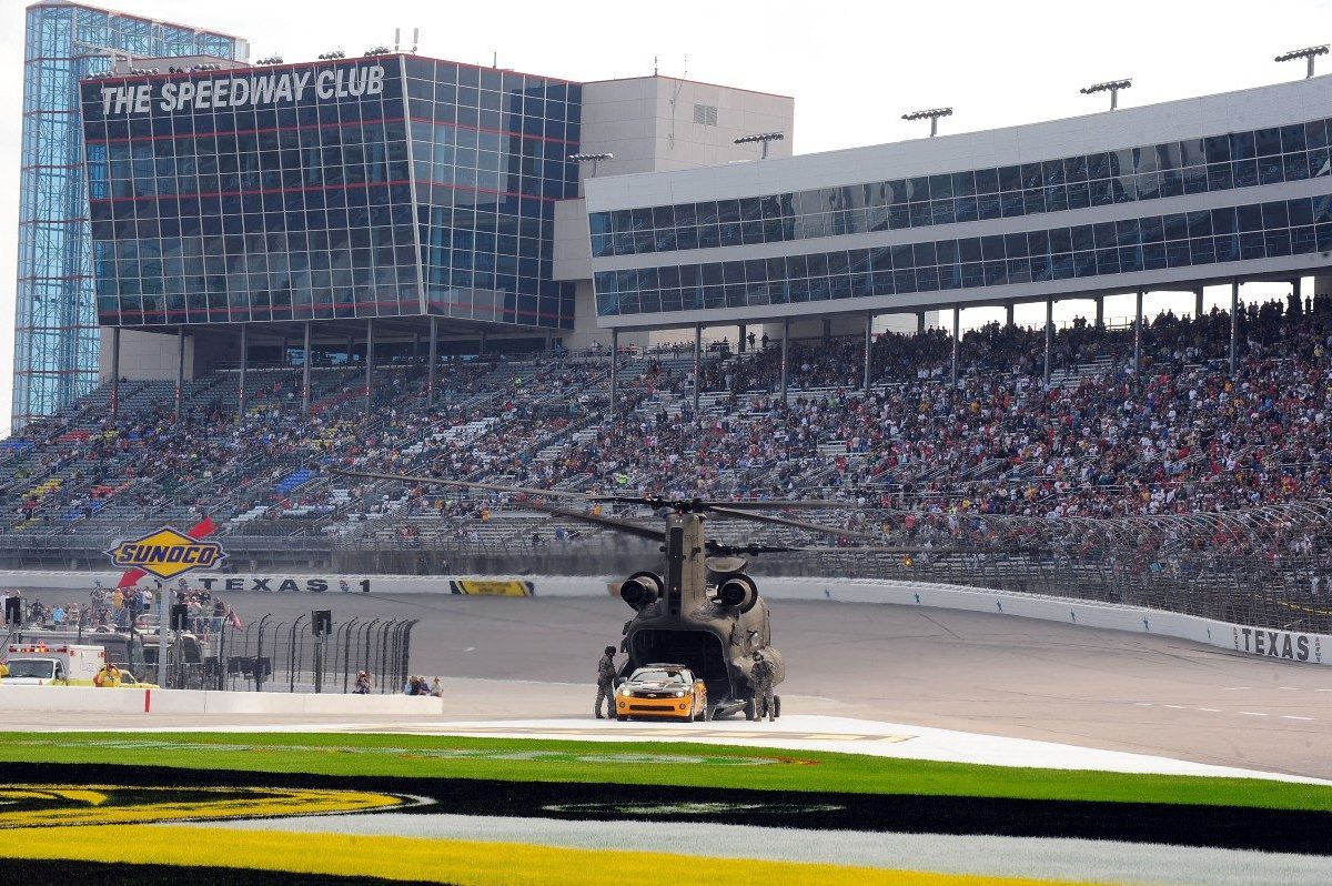 A Chinook helicopter, flown by Lt. Col. Doug Hurley, delievers the pace car during pre race ceremonies prior to the start of the NASCAR Sprint Cup Series Dickies 500 at Texas Motor Speedway on November 8, 2009 in Fort Worth, Texas