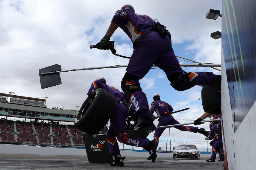 Pit crew members of the #11 FedEx Express Toyota, driven by Denny Hamlin, leap into action during the NASCAR Cup Series Season Finale 500 at Phoenix Raceway on November 08, 2020 in Avondale, Arizona