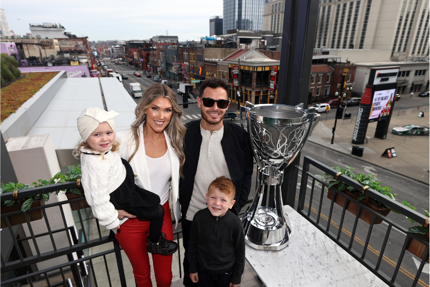 kyle larson with nascar cup trophy and wife and two kids