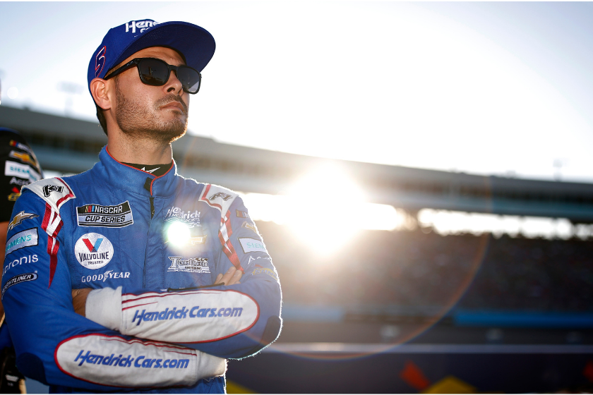 kyle larson with sunglasses looking off into distance