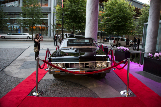 Fans admiring the prop car from the show while on display at the "Supernatural'" 200th episode celebration at the Fairmont Pacific Rim Hotel on October 18, 2014 in Vancouver, Canada
