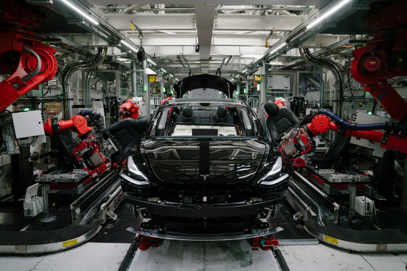 Robotics arms install the front seats to the Tesla Model 3 at the Tesla factory in Fremont, California