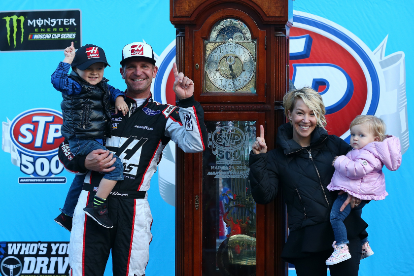 Clint Bowyer celebrates in Victory Lane with his wife Lorra and their children, Cash and Presley, after winning the weather delayed Monster Energy NASCAR Cup Series STP 500 at Martinsville Speedway on March 26, 2018 in Martinsville, Virginia
