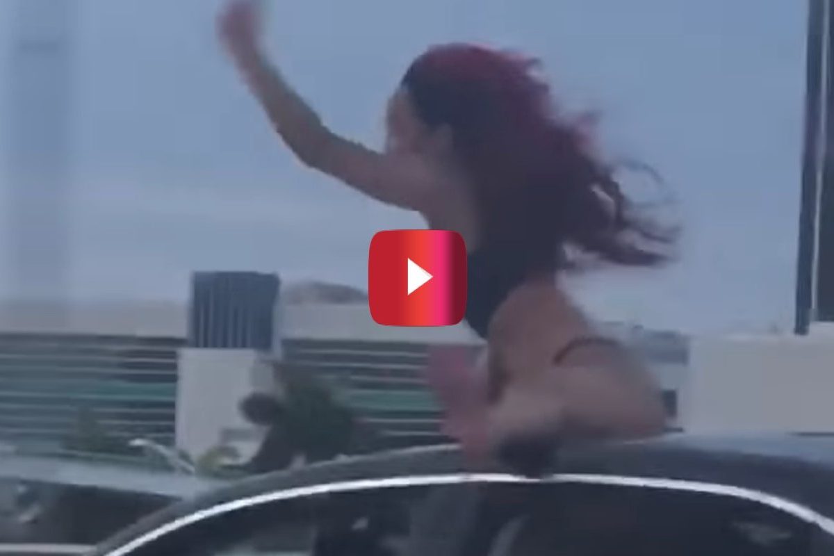 woman twerking on top of car