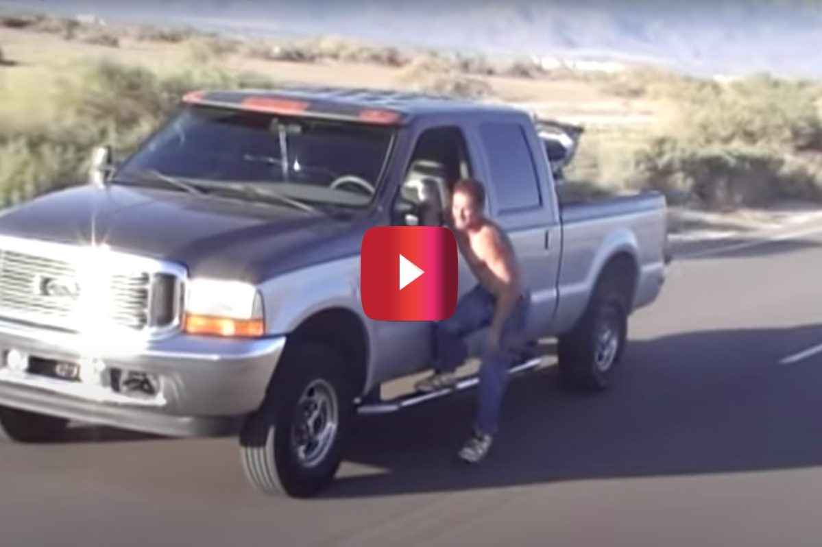driver hanging out of ford f-250