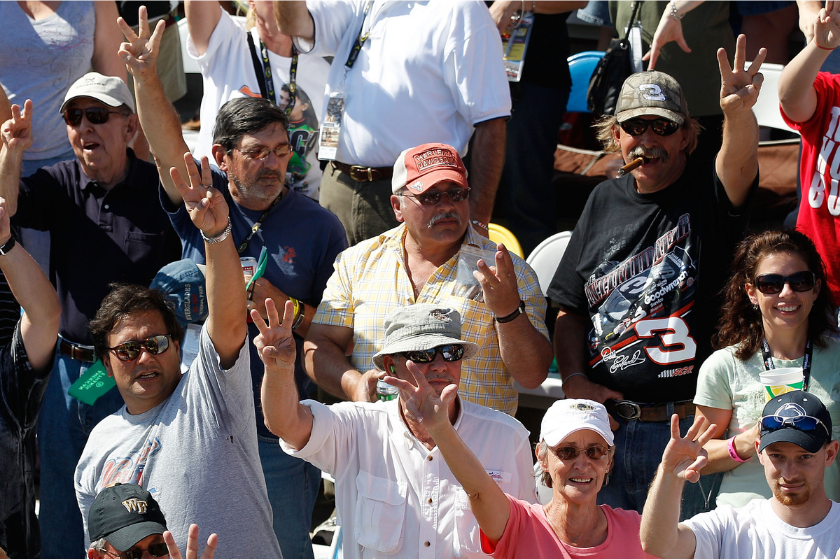 nascar fans holding up three fingers in honor of dale earnhardt