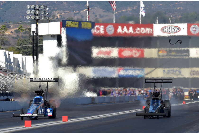 Top Fuel driver Antron Brown (left) defeats Cameron Ferre (right), as his blower belt flies off his dragster, during the semi final round of eliminations at the season ending 56th annual NHRA Finals at Pomona Raceway Sunday, Nov. 14, 2021