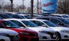 A dealership sign is seen outside of Honda certified used car dealership in Schaumburg, Ill., Thursday, Dec. 16, 2021