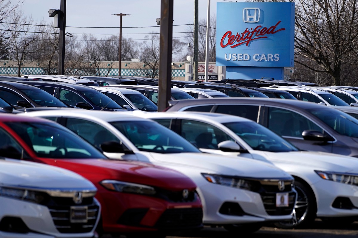A dealership sign is seen outside of Honda certified used car dealership in Schaumburg, Ill., Thursday, Dec. 16, 2021