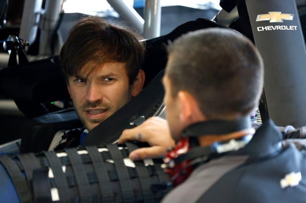 Daniel Suarez talks with his crew before taking the #1 Trackhouse Racing Chevrolet onto the track during NASCAR Cup Series Next Gen testing at Charlotte Motor Speedway on November 17, 2021 in Concord, North Carolina