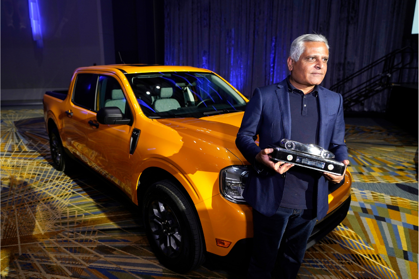 Kumar Galhotra, Ford President of the Americas and International markets group poses next to the Maverick compact pickup, Tuesday, Jan. 11 2022 in Detroit