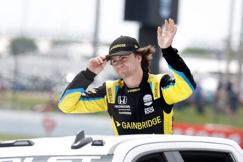Indy Car series driver Colton Herta waves to the fans during driver introductions before the Big Machine Spiked Coolers Grand Prix on August 14, 2021 on the Indianapolis Motor Speedway Road Course in Indianapolis, Indiana