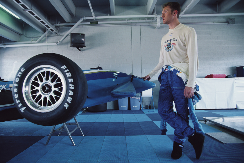 greg moore standing next to mercedes indycar