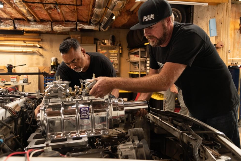 mike cotten and mike finnegan of faster with finnegan drop supercharger into car